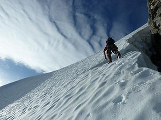 Sergio climbing steep snow below the summit.