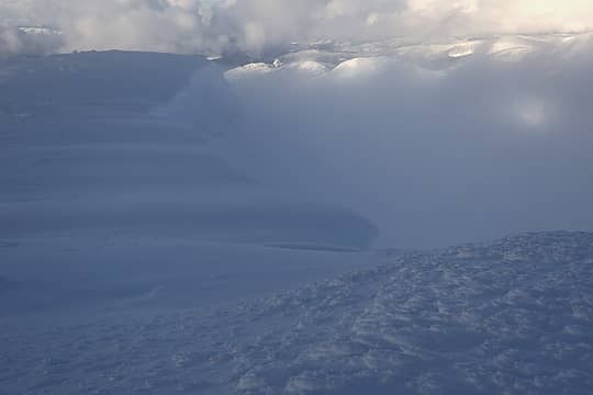 Cloudy view off the big summit cornices