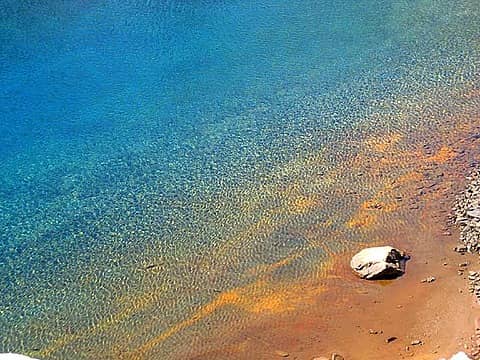Tainted sand makes for a colorful shore.