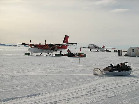 Loading the Twin Otter, with the Basler BT-67 in background